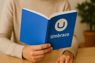 Image or a person holding an Umbraco manual