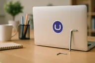 Image of an open laptop with an Umbraco sticker and an allen key